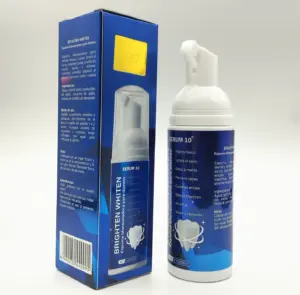 Frasco dispensador blanco de espuma dental Serum 10 y su caja azul con información, diseño compacto para higiene oral y blanqueamiento.